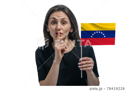 Happy young white woman holding flag of Venezuela and holds a finger to her lips isolated on a white background Happy young white woman holding flag of Venezuela and holds a finger to her lips isolated on a white background 78419226
