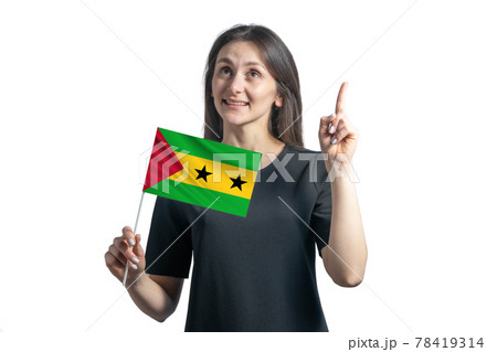 Happy young white woman holding flag of Sao Tome and Principe and points thumbs up isolated on a white background Happy young white woman holding flag of Sao Tome and Principe and points thumbs up isolated on a white background 78419314