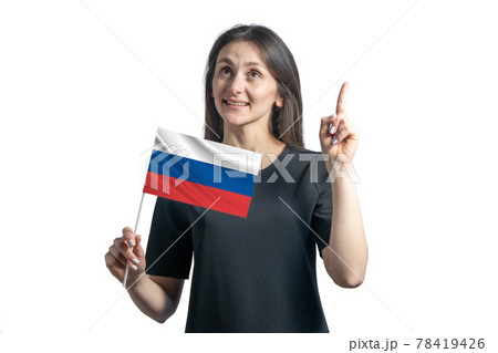 Happy young white woman holding flag of Russia and points thumbs up isolated on a white background 78419426