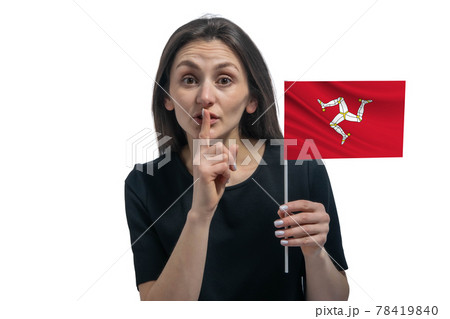 Happy young white woman holding flag of Isle of Man and holds a finger to her lips isolated on a white background Happy young white woman holding flag of Isle of Man and holds a finger to her lips isolated on a white background 78419840
