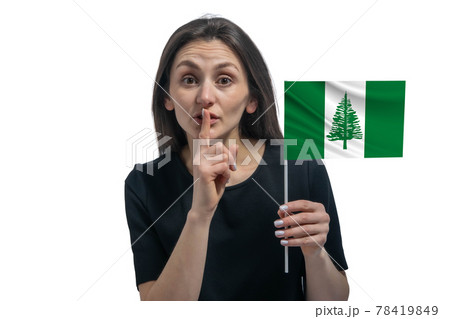 Happy young white woman holding flag of Norfolk Island and holds a finger to her lips isolated on a white background Happy young white woman holding flag of Norfolk Island and holds a finger to her lips isolated on a white background 78419849