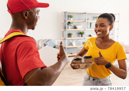 African Delivery Guy And Happy Female Customer Gesturing Thumbs-Up Indoor African Delivery Guy And Happy Female Customer Gesturing Thumbs-Up Indoor 78419957