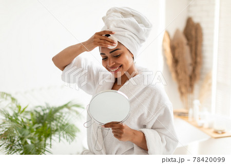 Black Lady Removing Makeup With Cotton Pad In Bathroom 78420099