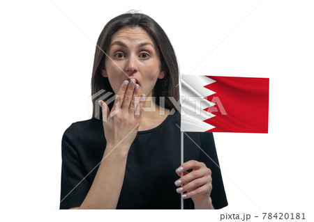 Happy young white woman holding flag of Bahrain and covers her mouth with her hand isolated on a white background 78420181
