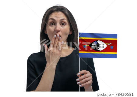 Happy young white woman holding flag of Esvatini and covers her mouth with her hand isolated on a white background Happy young white woman holding flag of Esvatini and covers her mouth with her hand isolated on a white background 78420581