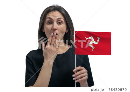 Happy young white woman holding flag of Isle of Man and covers her mouth with her hand isolated on a white background 78420679