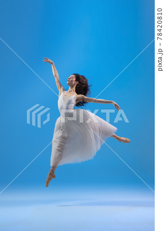 Young and graceful ballet dancer isolated on blue studio background. Art, motion, action, flexibility, inspiration concept. Young and graceful ballet dancer isolated on blue studio background. Art, motion, action, flexibility, inspiration concept. 78420810