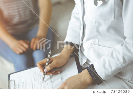 Close-up of woman-doctor and patient discussing current health examination while sitting indoors. Stay at home concept during Coronavirus pandemic and self isolation quarantine. Covid 2019 78424089