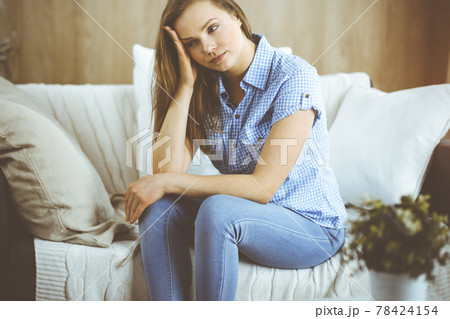 Tired upset woman worried about tiredness from domestic work and self isolation quarantine for COVID-19 Coronavirus 78424154