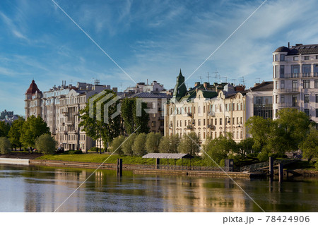 Houses on the embankment are reflected in Srednyaya Nevka river of Petersburg 78424906
