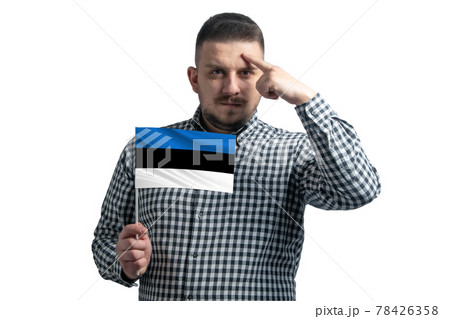 White guy holding a flag of Estonia and a finger touches the temple on the head isolated on a white background 78426358
