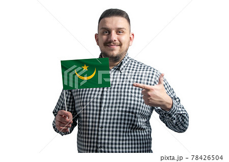 White guy holding a flag of Mauritania and points the finger of the other hand at the flag isolated on a white background White guy holding a flag of Mauritania and points the finger of the other hand at the flag isolated on a white background 78426504
