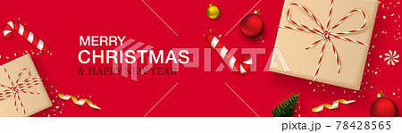 Merry Christmas and New Year horizontal banner. Red background with realistic gift boxes in craft paper, Christmas balls, christmas tree, candy and golden confetti. Header for website. Merry Christmas and New Year horizontal banner. Red background with realistic gift boxes in craft paper, Christmas balls, christmas tree, candy and golden confetti. Header for website. 78428565