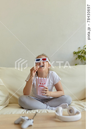 childhood and leisure at home concept - emotional little girl in 3d glasses 78430697