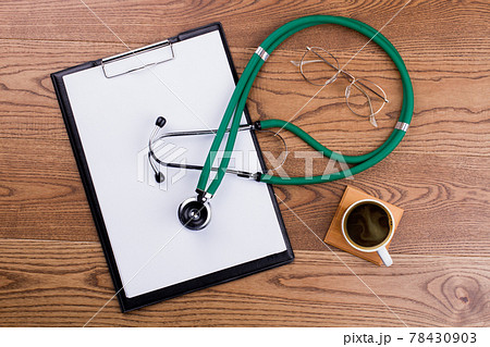 Blank clipboard with modern stethoscope and cup of coffee. Blank clipboard with modern stethoscope and cup of coffee. 78430903