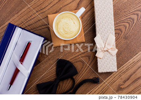 Cup of coffee with gift boxes and bow tie. Cup of coffee with gift boxes and bow tie. 78430904