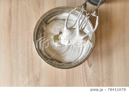 Whipped egg whites and other ingredients for cream on wooden table, closeup 78431079