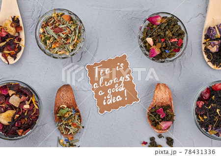 Spoons and bowls with different type of dry tea leaves. 78431336