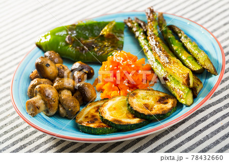 Assortment of delicious grilled organic vegetables served on blue ceramic plate. Assortment of delicious grilled organic vegetables served on blue ceramic plate. 78432660
