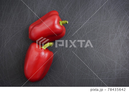 Close-up. Colorful, fancy red bell or sweet peppers flat lay on grunge scratched texture black background. Off-center with copy space, top view, horizontal image style. 78435642