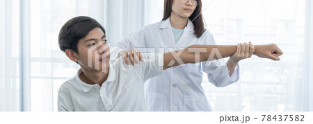 Female doctor hand doing physical therapy By extending the hand of a male patient 78437582