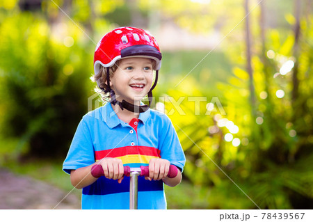 Little boy riding scooter. Kids ride kick board. Little boy riding scooter. Kids ride kick board. 78439567