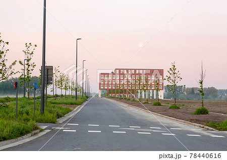 Street in the landscape and in the end a big building 78440616