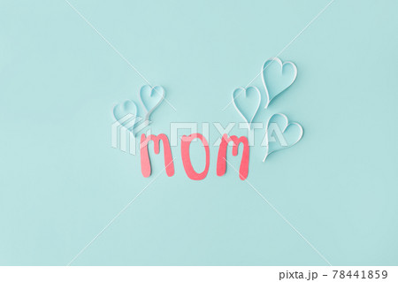 Mothers day message on paper cut hearts over blue background, simple diy creative idea, banner, greeting card for mom Mothers day message on paper cut hearts over blue background, simple diy creative idea, banner, greeting card for mom 78441859