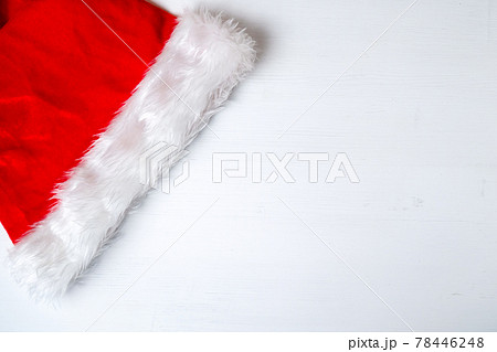 Santa Claus red hat on white wooden background with copy space. Santa Claus red hat on white wooden background with copy space. 78446248