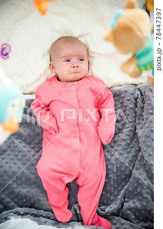 Newborn with very sad face start to cry 78447397