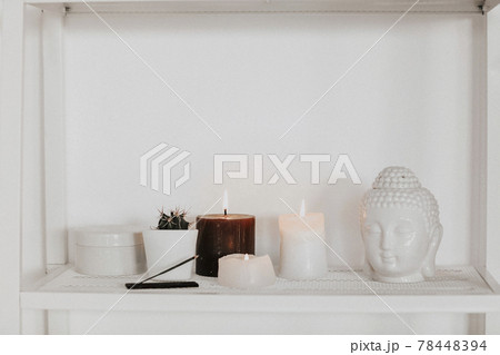 Candles and incense near Buddha head and cactus Candles and incense near Buddha head and cactus 78448394