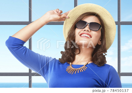 Asian woman standing with hat and sunglasses on the resort Asian woman standing with hat and sunglasses on the resort 78450137