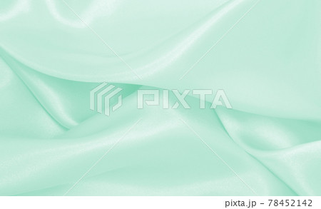 Smooth elegant green silk or satin luxury cloth texture as abstract background. Luxurious background design 78452142