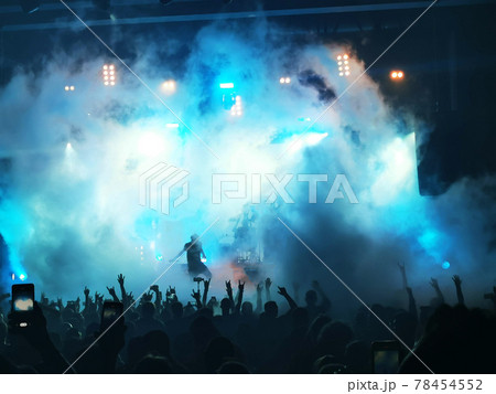 silhouettes of concert crowd in front of bright stage lights silhouettes of concert crowd in front of bright stage lights 78454552