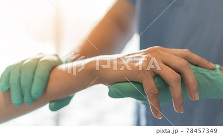 Surgeon, surgical doctor holding patient hand in professional ER emergency operation room for health care trust, medical anesthetic safety by anesthetist or anesthesiologist healthcare support concept 78457349