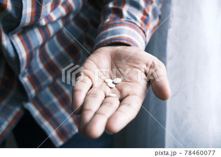 close up of white color medical pill on palm of hand  78460077