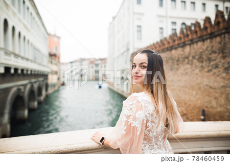 Beauty portrait of bride wearing fashion wedding dress with feathers with luxury delight make-up and hairstyle 78460459