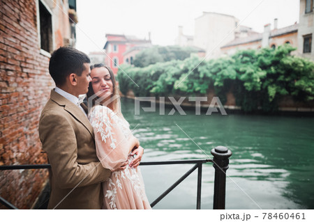 Wedding couple on the nature is hugging each other. Beautiful model girl in white dress. Man in suit Wedding couple on the nature is hugging each other. Beautiful model girl in white dress. Man in suit 78460461