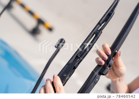 Faceless woman changing car windshield wipers. 78460542