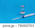 Vaccine for treatment of COVID-19 coronavirus with syringe on blue background with space for text. World vaccination against SARS-nCoV epidemic. Concept fighting and defeating coronavirus 2019-nCoV. 78460703