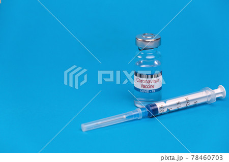 Vaccine for treatment of COVID-19 coronavirus with syringe on blue background with space for text. World vaccination against SARS-nCoV epidemic. Concept fighting and defeating coronavirus 2019-nCoV. 78460703