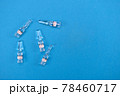 Glass ampoules for injection with coronavirus vaccine on blue background with space for text. Concept of fighting Sars-nCov, vaccinating people against Covid19 virus. Invention vaccine from 2019-nCoV 78460717