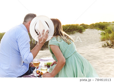Happy couple drinking wine during picnic Happy couple drinking wine during picnic 78461013