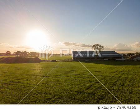 Colorful sunrise or sunset sky over a farmfield shot from high up 78464369
