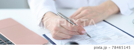Doctor filling out patients medical history in clinic closeup Doctor filling out patients medical history in clinic closeup 78465145