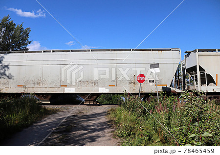 A train speeds past a stop sign at a crossing 78465459