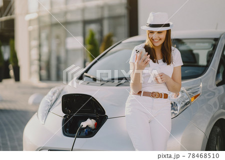 Woman charging electro car at the electric gas station Woman charging electro car at the electric gas station 78468510