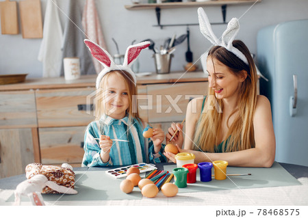 Mother with little daughter in a kitchen 78468575