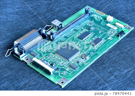 The picture shows a working printed circuit board in a dark room on the table. The picture shows a working printed circuit board in a dark room on the table. 78470441