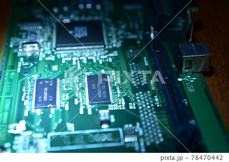 Close-up of a printed circuit board lying on a table. 78470442